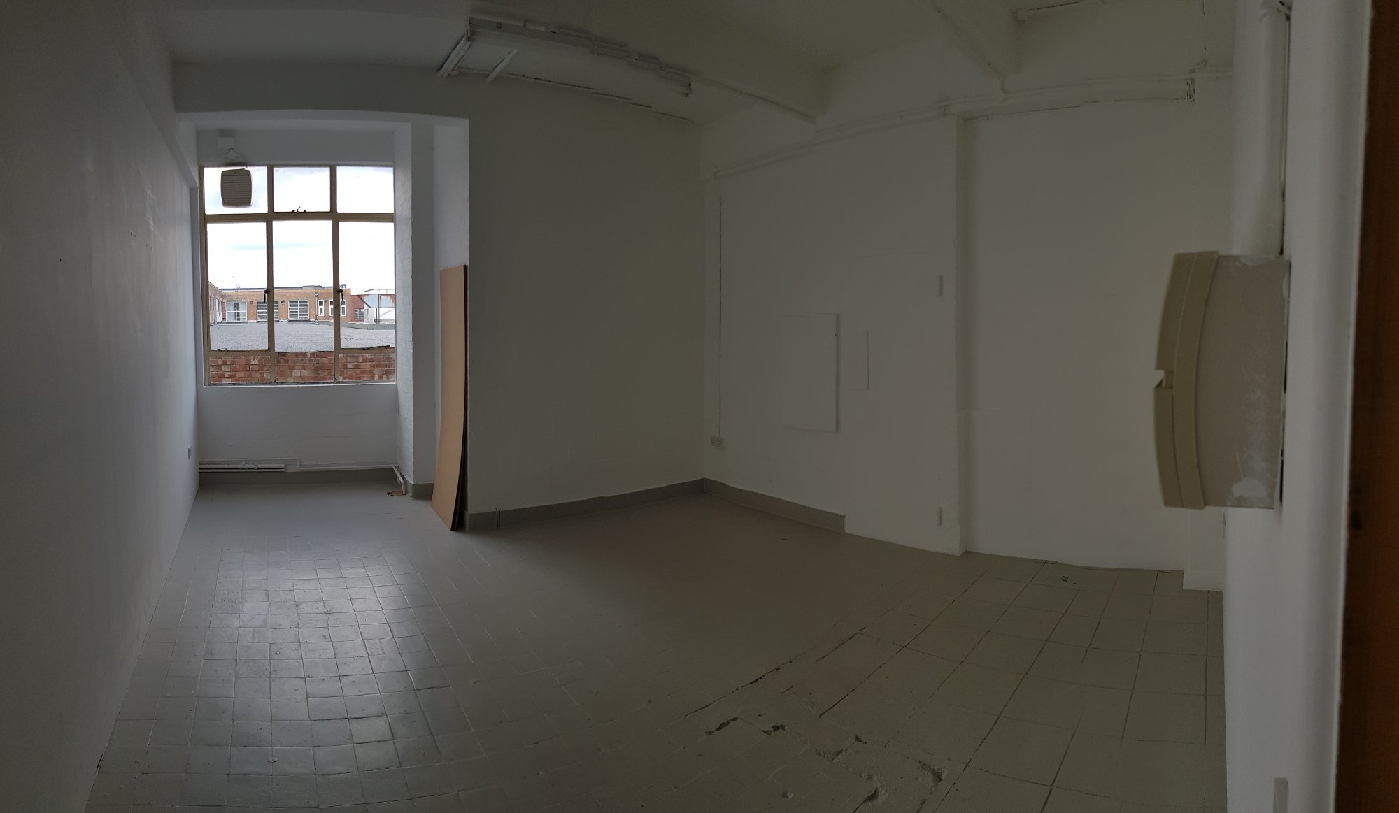 Bright art studio interior at Stewkley House with large window and white walls